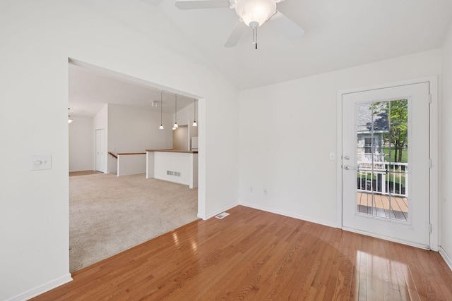 574 Marsh Dr, Delano, MN 55328 - empty room featuring vaulted ceiling, wood finished floors, a ceiling fan, and baseboards