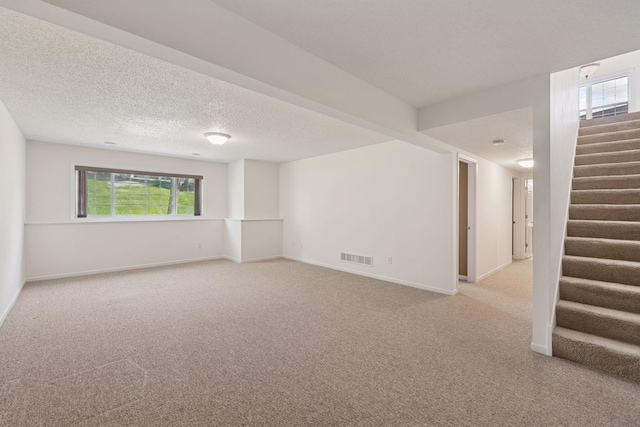 574 Marsh Dr, Delano, MN 55328 - carpeted spare room with stairs, baseboards, and a textured ceiling