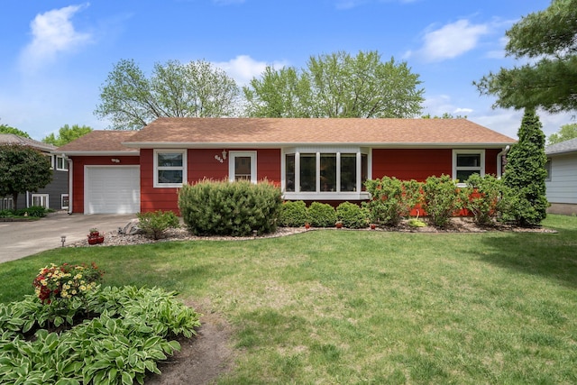 single story home with an attached garage, a front yard, and driveway