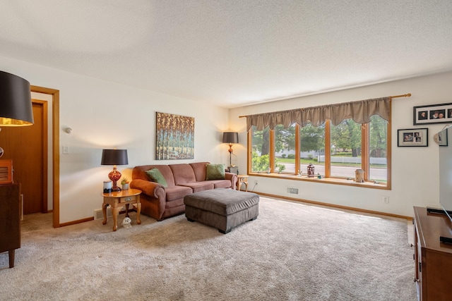carpeted living room with baseboards and a textured ceiling