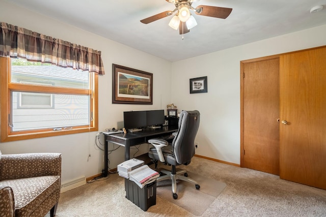 office space with light colored carpet, a ceiling fan, baseboards, and a baseboard heating unit