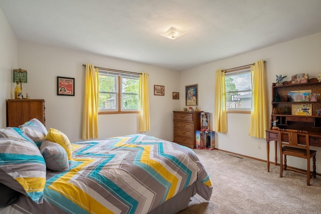 bedroom with carpet flooring and baseboards