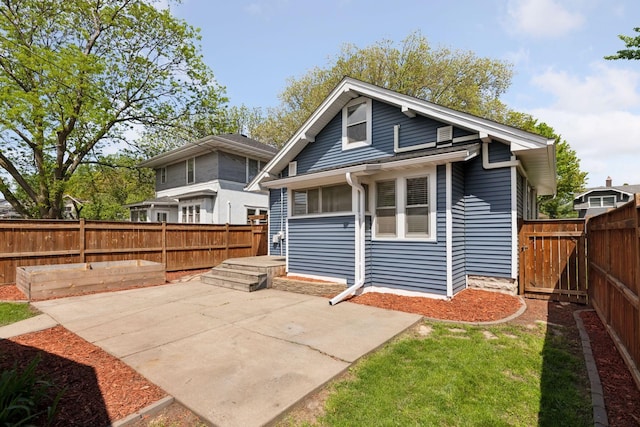 back of property featuring a patio and a fenced backyard