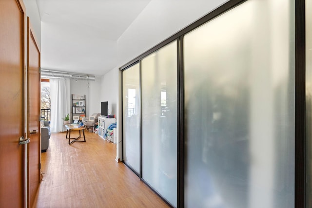 corridor with light wood-style floors