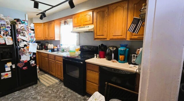 139 2nd St W, Wabasha, MN 55981 - kitchen featuring black appliances, under cabinet range hood, light countertops, and brown cabinets