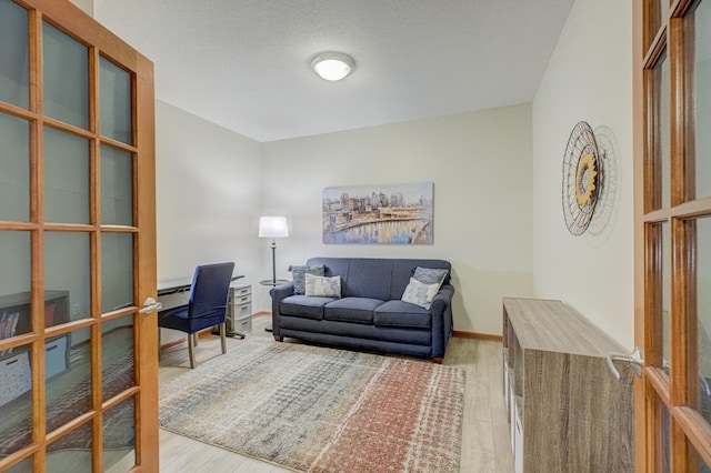office with wood finished floors and a baseboard radiator