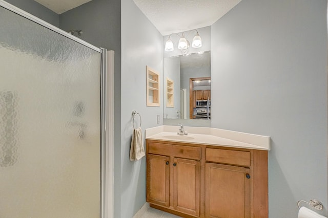 bathroom featuring a shower stall, vanity, and baseboards