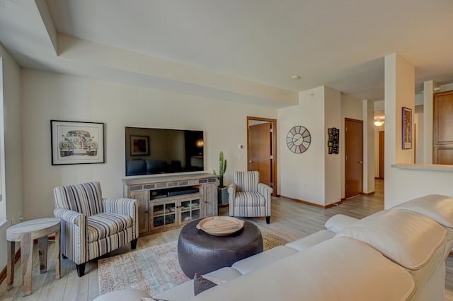 living room featuring light wood-style flooring and baseboards