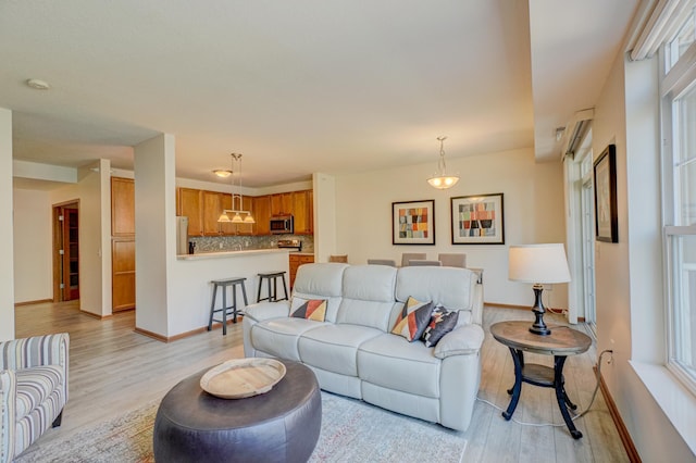 living room featuring light wood finished floors and baseboards