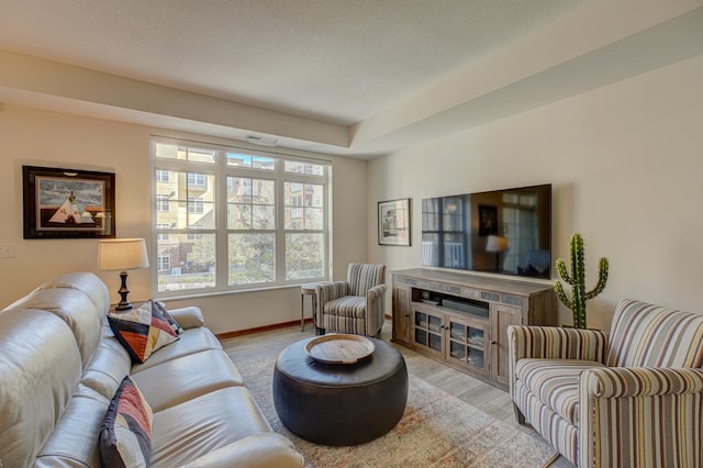 living room featuring wood finished floors and baseboards