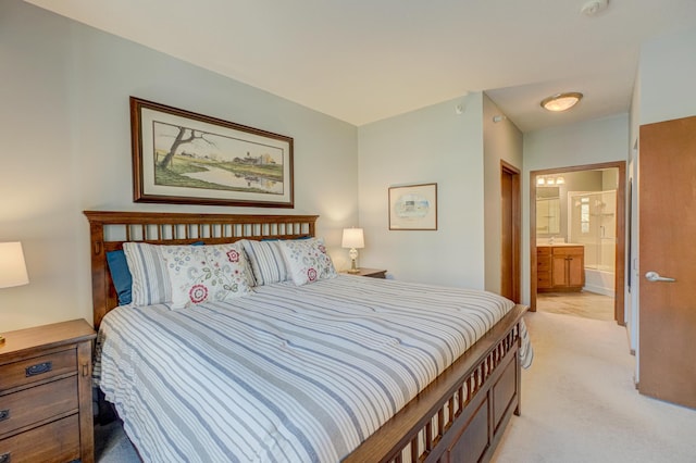bedroom with light carpet and ensuite bathroom