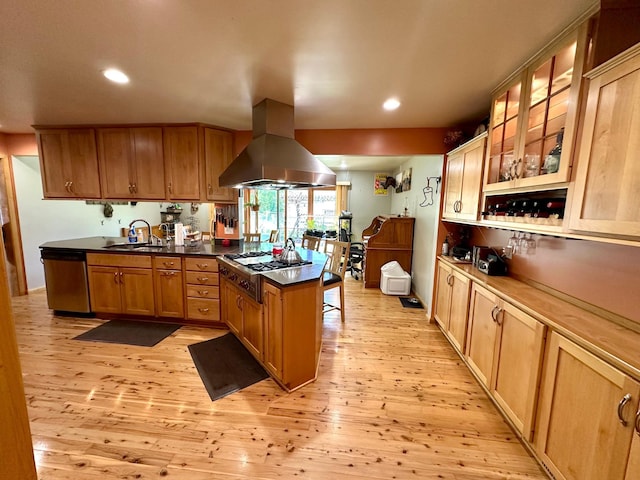 kitchen with island exhaust hood, stainless steel appliances, a peninsula, light wood finished floors, and recessed lighting