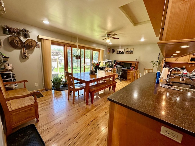 dining room with light wood finished floors, a ceiling fan, and recessed lighting