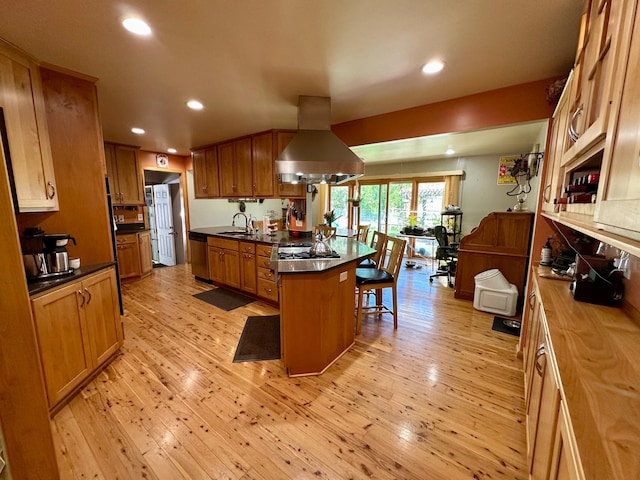 kitchen featuring island exhaust hood, stainless steel dishwasher, a breakfast bar area, recessed lighting, and light wood-type flooring