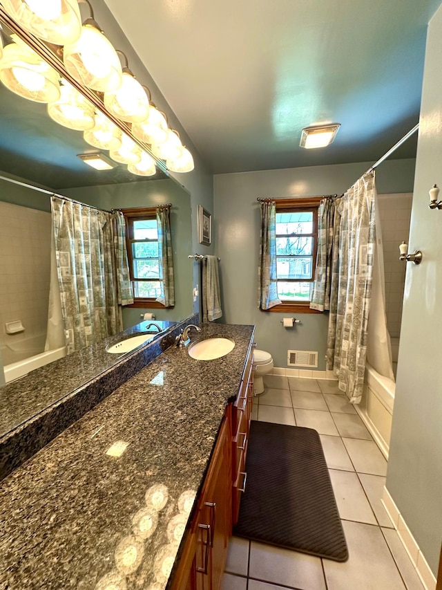full bathroom featuring tile patterned flooring, toilet, shower / bath combo, vanity, and baseboards