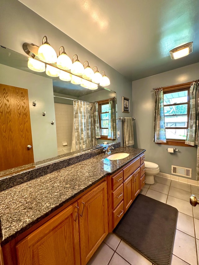 bathroom featuring tile patterned flooring, toilet, vanity, a shower with shower curtain, and baseboards