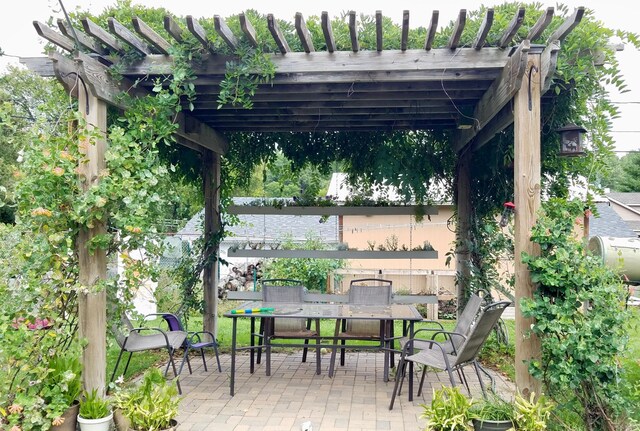 view of patio featuring outdoor dining space and a pergola