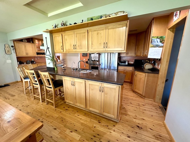 2127 S Ave E, North Saint Paul, MN 55109 - kitchen featuring a sink, light wood-style floors, and light brown cabinetry