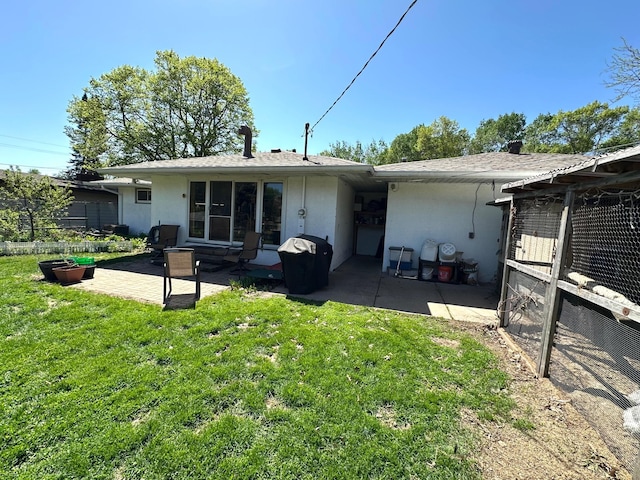 2127 S Ave E, North Saint Paul, MN 55109 - back of house with a patio area, stucco siding, and a yard