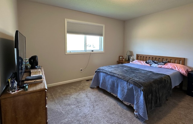 bedroom featuring carpet floors, baseboards, and a textured ceiling