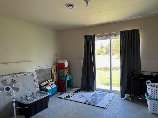 recreation room featuring concrete flooring and healthy amount of natural light