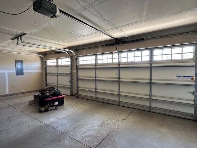 garage with a garage door opener and electric panel