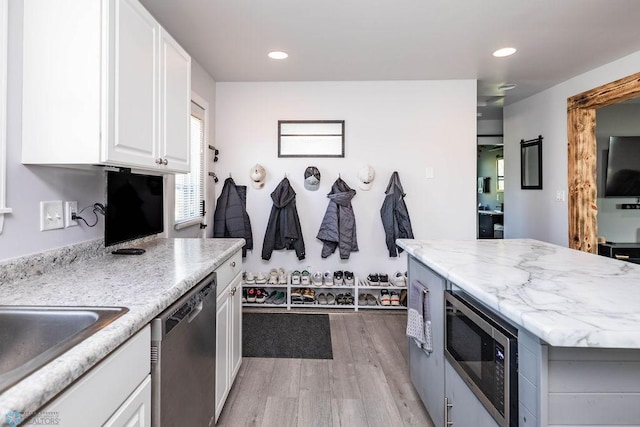 12606 Abbey Lake Ln, Lake View Twp, MN 56501 - kitchen featuring appliances with stainless steel finishes, white cabinetry, light wood finished floors, recessed lighting, and a kitchen island
