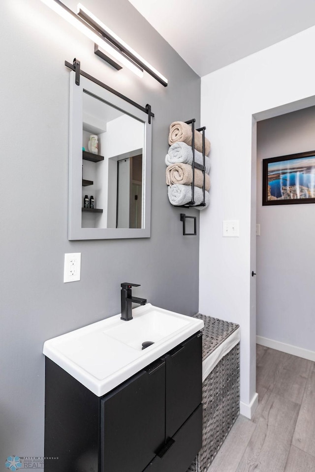 12606 Abbey Lake Ln, Lake View Twp, MN 56501 - bathroom with wood finished floors, vanity, and baseboards