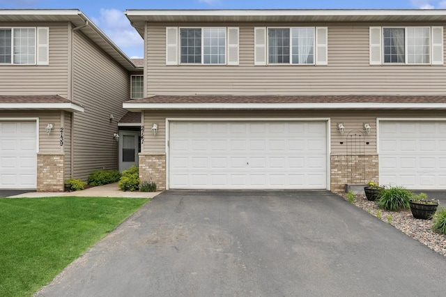 2141 Cleveland Ln S, Cambridge, MN 55008 - view of front of house featuring brick siding, asphalt driveway, and an attached garage