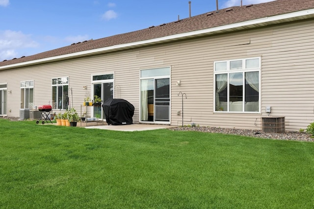 2141 Cleveland Ln S, Cambridge, MN 55008 - back of house featuring a yard, a patio area, and a shingled roof