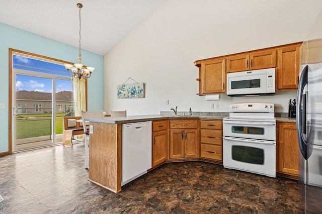 2141 Cleveland Ln S, Cambridge, MN 55008 - kitchen with white appliances, a chandelier, a peninsula, brown cabinetry, and high vaulted ceiling