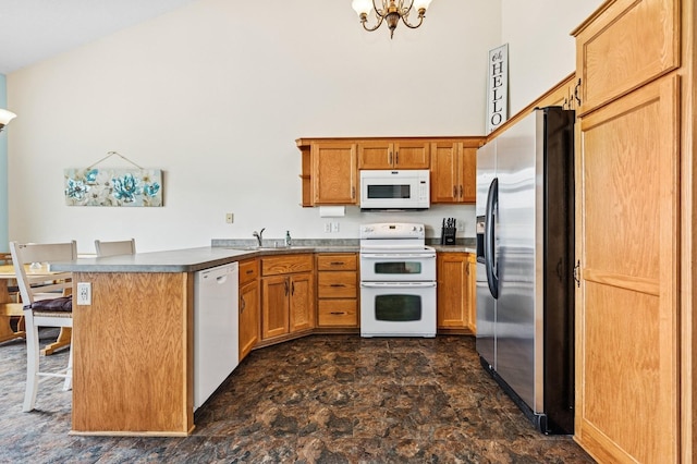 2141 Cleveland Ln S, Cambridge, MN 55008 - kitchen featuring white appliances, a peninsula, stone finish flooring, a chandelier, and brown cabinets