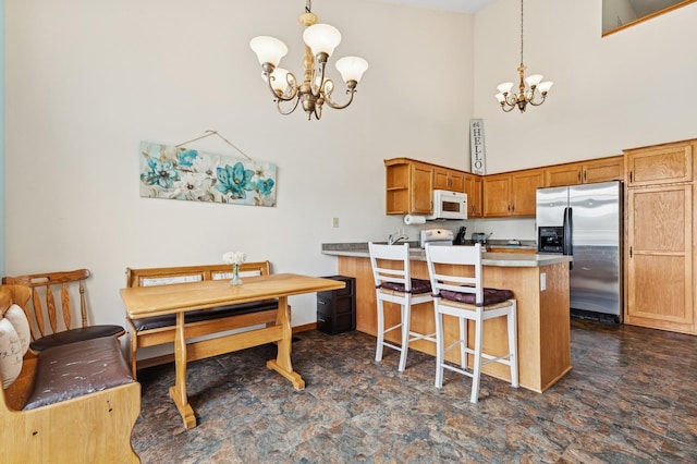 2141 Cleveland Ln S, Cambridge, MN 55008 - dining room featuring a chandelier, a towering ceiling, and stone finish flooring