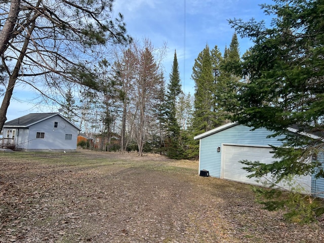 11749 Side Dr, Fine Lakes Twp, MN 55798 - view of yard featuring an outbuilding and a detached garage