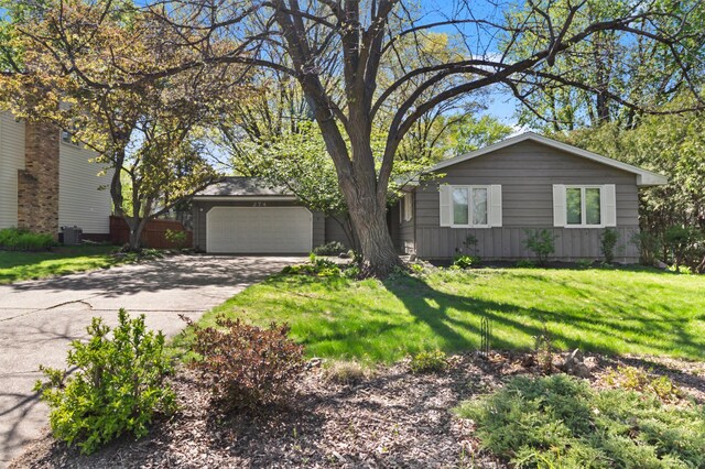 274 17th Ave NW, New Brighton, MN 55112 - view of front of house with an attached garage, driveway, and a front lawn