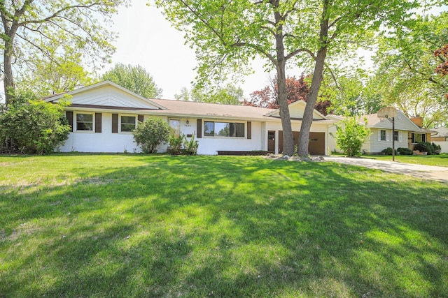 single story home with a garage, driveway, and a front lawn