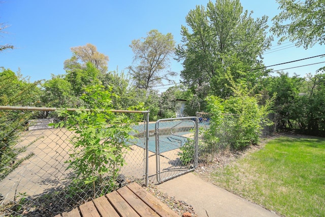 view of swimming pool with a gate and fence