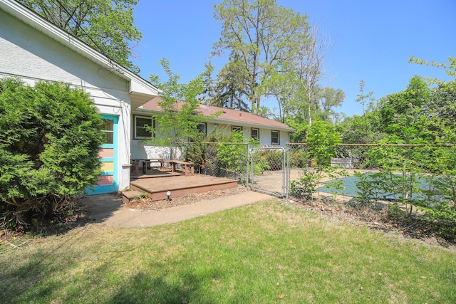view of yard featuring a gate and a deck