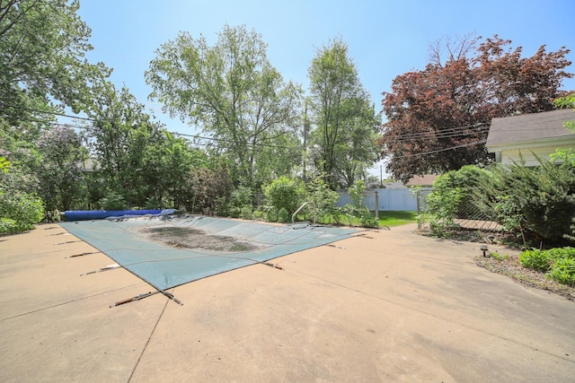 view of pool featuring a patio and fence