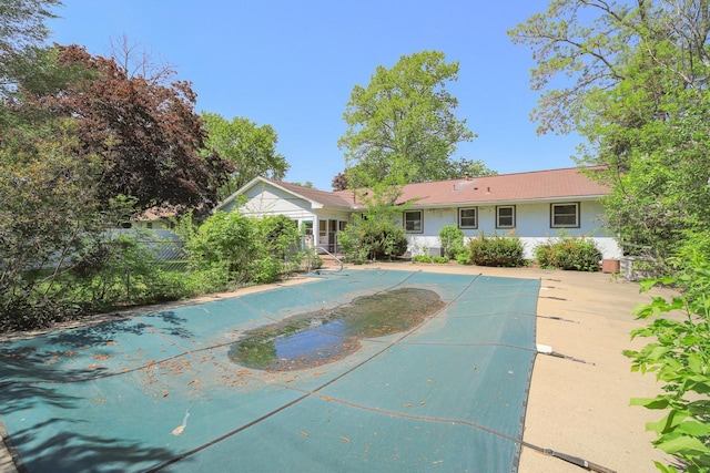 view of pool featuring a covered pool and fence