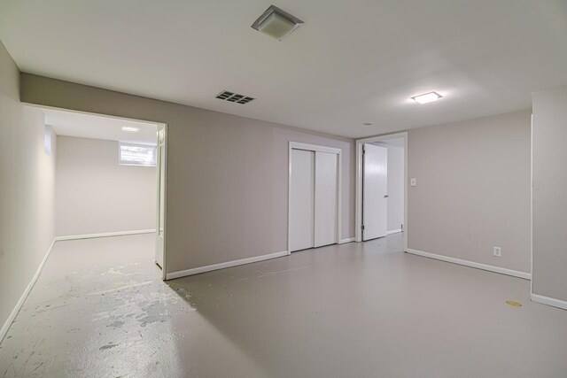 empty room with baseboards and finished concrete floors