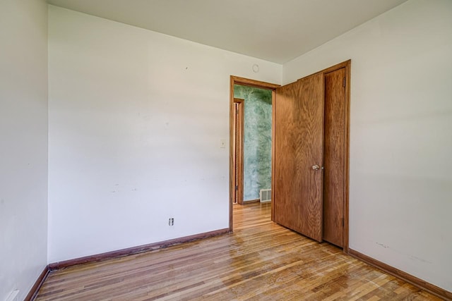 unfurnished room featuring light wood-style floors and baseboards