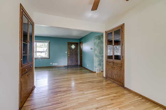 foyer with ceiling fan, light wood finished floors, and baseboards