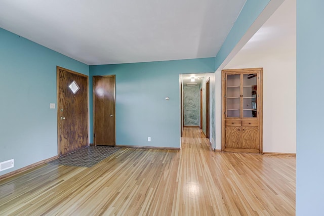 unfurnished bedroom featuring light wood finished floors and baseboards
