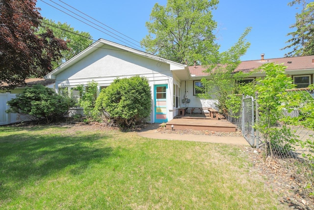 back of house with a deck and stucco siding