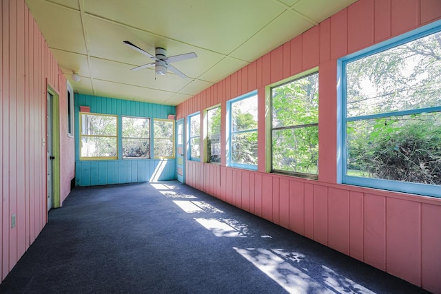 unfurnished sunroom with a ceiling fan