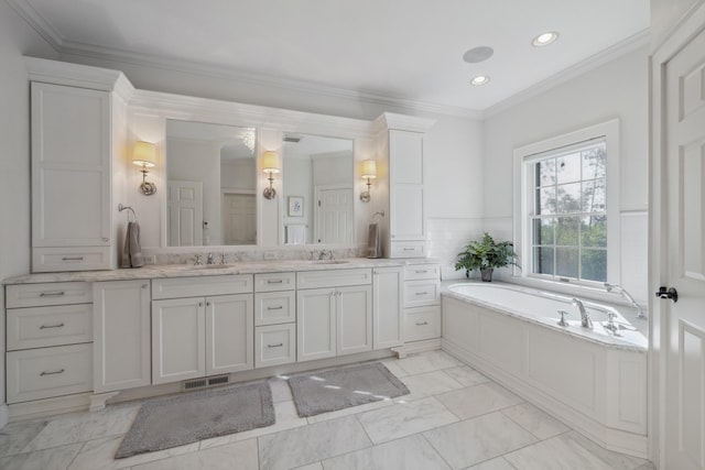 full bath with marble finish flooring, double vanity, a garden tub, recessed lighting, and crown molding