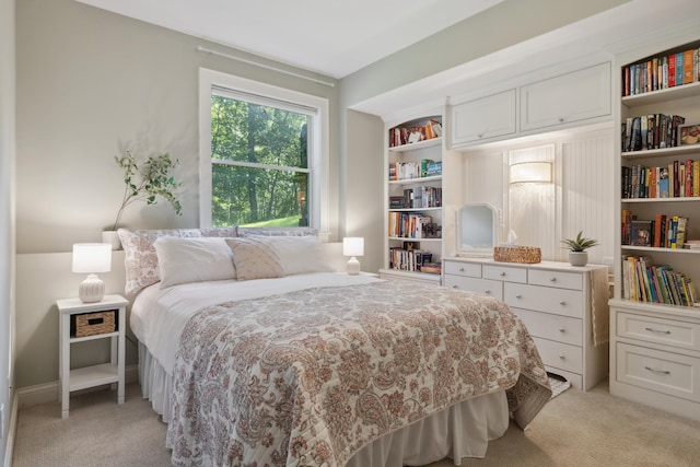 bedroom featuring light colored carpet