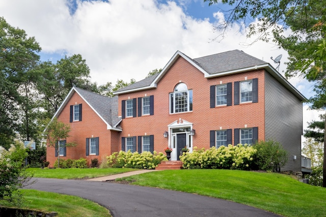 1924 Norway Pine Rd, East Gull Lake, MN 56401 - colonial-style house with a front lawn, brick siding, and a shingled roof