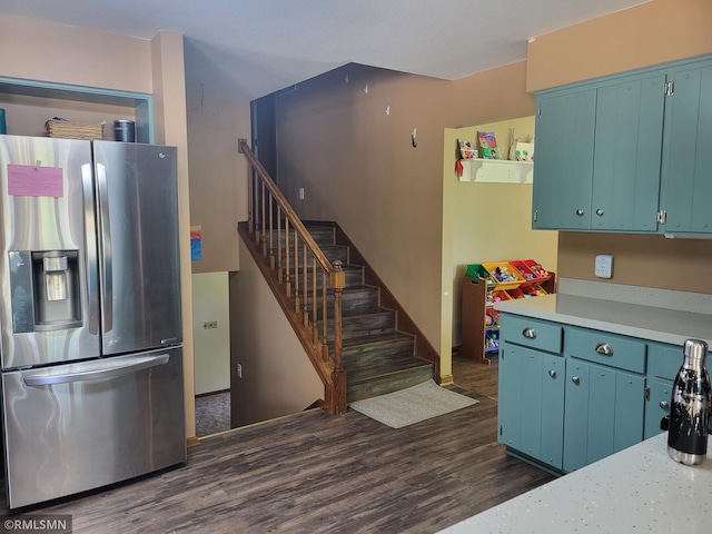 8743 Unit Ave, Stewart, MN 55385 - kitchen featuring stainless steel fridge with ice dispenser, dark wood-type flooring, light countertops, and blue cabinets